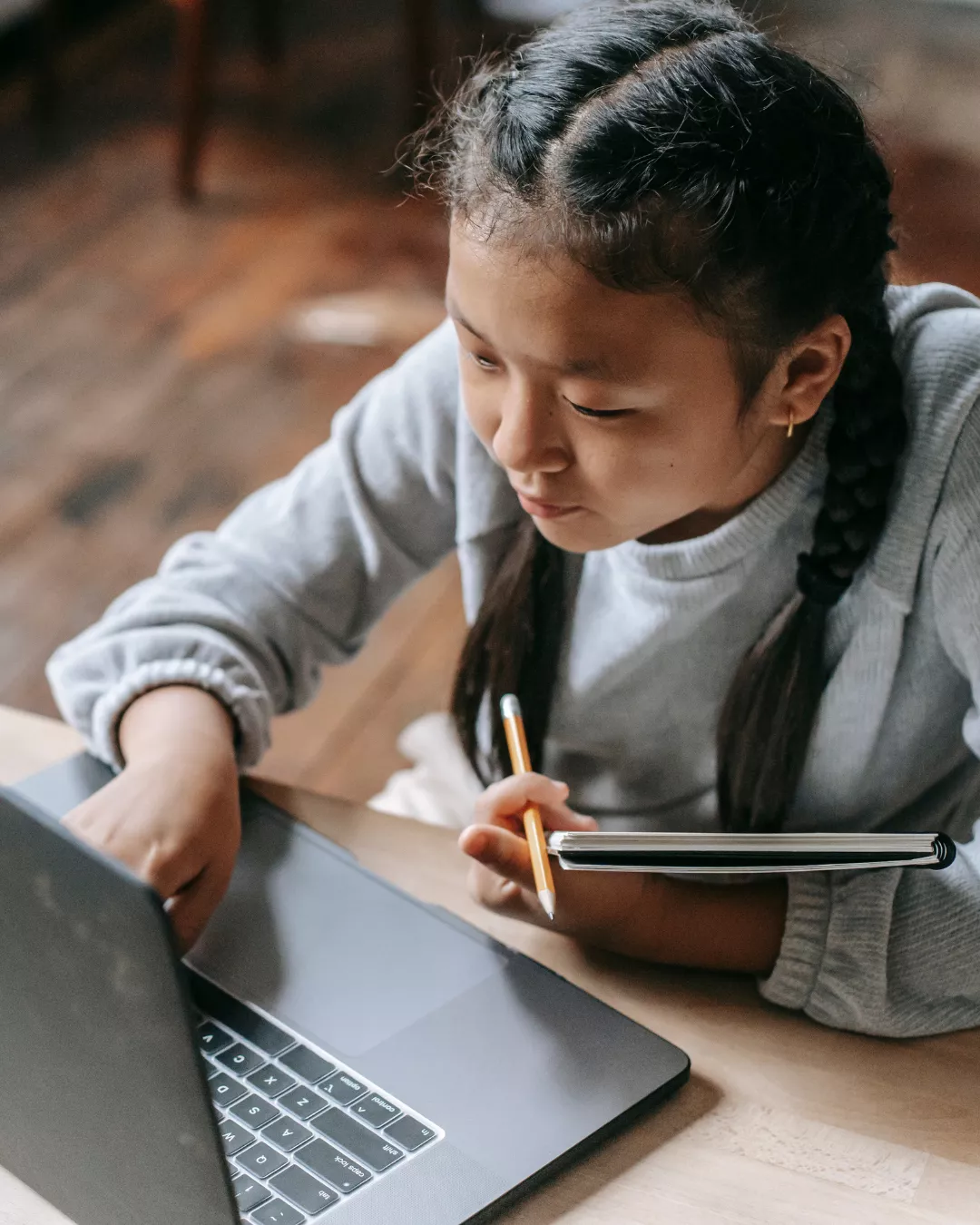 Child doing homework on a laptop